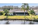 Inviting backyard with screened-in pool overlooking a tranquil lake at 3360 Hickorywood Way, Tarpon Springs, FL 34688