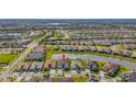 Bird's-eye view of a house in a large residential area near a lake at 4919 Pamplona Ct., Wimauma, FL 33598