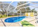 Relaxing kidney-shaped pool with screened enclosure and lounge chairs at 1010 59Th N Ave, St Petersburg, FL 33703