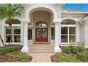 Elegant front door entrance with columns and brick pathway at 10106 Radcliffe Dr, Tampa, FL 33626
