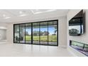 Living area with sliding glass doors and fireplace at 10639 Ruffino Ct, Trinity, FL 34655