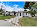 White single-story home with a brick walkway and arched entryway at 11303 Leprechaun Dr, Riverview, FL 33569