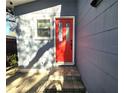 Bright red front door entry with brick walkway at 143 44Th N Ave, St Petersburg, FL 33703