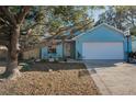Charming blue single-Gathering home with a well-maintained lawn and a one-car garage at 5524 Kentucky Ave, New Port Richey, FL 34652