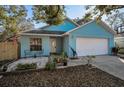Charming blue single-Gathering home with a well-maintained lawn and a one-car garage at 5524 Kentucky Ave, New Port Richey, FL 34652