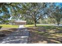 Long driveway leading to a home and detached garage at 8345 Shenandoah Run, Wesley Chapel, FL 33544