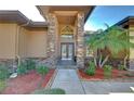 Inviting entryway with double doors and stone columns at 8345 Shenandoah Run, Wesley Chapel, FL 33544