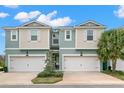 Two-story townhome with two-car garage and neutral color palette at 1003 Starboard Ct, Oldsmar, FL 34677