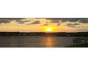 Scenic sunset over calm water with a bridge and pier at 1003 Starboard Ct, Oldsmar, FL 34677