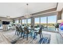Elegant dining room with glass table and modern chairs at 20001 Gulf Blvd # 501, Indian Shores, FL 33785