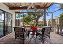 Relaxing screened porch with wicker furniture overlooking the canal at 9386 Tradewinds Ave, Seminole, FL 33776