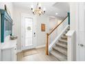 Bright and spacious entryway with staircase and decorative accents at 14672 Horse Trot Rd, Lithia, FL 33547