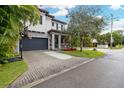 Two-story home with gray siding, a dark gray garage door, and a basketball hoop at 1839 46Th N Ave, St Petersburg, FL 33714