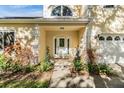 Inviting front entrance with a white door, and nicely landscaped walkway at 2122 Oak Forest Ln, Palm Harbor, FL 34683