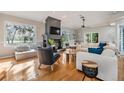 Bright and airy living room with hardwood floors, a fireplace and plenty of natural light at 2122 Oak Forest Ln, Palm Harbor, FL 34683