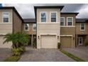 Two-story townhome with a two-car garage, neatly landscaped and situated in a community setting at 29955 Southwell Ln, Wesley Chapel, FL 33543