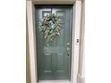 Inviting green front door adorned with a stylish wreath at 29955 Southwell Ln, Wesley Chapel, FL 33543