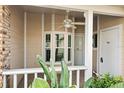 Front porch with white columns, ceiling fan, and bay window at 6506 Remus Dr, New Port Richey, FL 34653