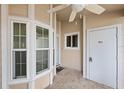 Front porch with white columns, ceiling fan, and bay window at 6506 Remus Dr, New Port Richey, FL 34653