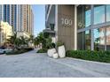 Modern building entrance with landscaping and city backdrop at 100 1St N Ave # 1601, St Petersburg, FL 33701
