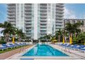 Resort-style pool with plenty of lounge chairs and umbrellas at 100 1St N Ave # 1601, St Petersburg, FL 33701