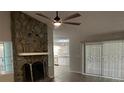 Living room with stone fireplace and view into the kitchen at 1311 4Th W St, Palmetto, FL 34221