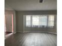 Spacious living room with bay windows and laminate floors at 1311 4Th W St, Palmetto, FL 34221