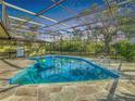 Inviting screened pool area with flagstone decking at 1791 Braxton Bragg Ln, Clearwater, FL 33765