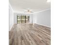 Spacious living room featuring vinyl flooring and access to patio at 3505 Tarpon Woods Blvd # K403, Palm Harbor, FL 34685
