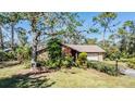Single-story home with stone accents and a spacious lawn at 4595 Northwood Ter, Sarasota, FL 34234