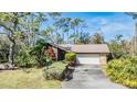 House with a large driveway and lush landscaping at 4595 Northwood Ter, Sarasota, FL 34234
