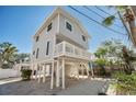 Two-story house with gray siding, elevated foundation, and balcony at 820 Gulf Blvd # S 1-3, Indian Rocks Beach, FL 33785