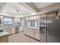 Kitchen with stainless steel appliances and light wood cabinets at 8436 Red Roe Dr, New Port Richey, FL 34653