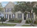 Three-story townhome with black front door and nicely landscaped yard at 9910 New Parke Rd, Tampa, FL 33626