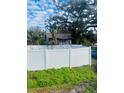 Home with a white vinyl fence and lush green landscaping at 1608 S 45Th St, Tampa, FL 33619