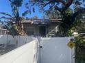 Small house with white picket fence and mature trees at 1608 S 45Th St, Tampa, FL 33619