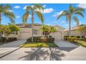 Exterior view of a lovely villa with lush landscaping at 2290 Sifield Greens Way, Sun City Center, FL 33573