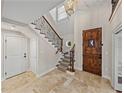 Bright entryway with a grand staircase and tiled floors at 307 Harbor View Ln, Largo, FL 33770