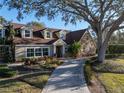 Two-story house with stone accents and a long driveway at 307 Harbor View Ln, Largo, FL 33770