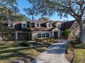 Spacious home with a large yard and a circular driveway at 307 Harbor View Ln, Largo, FL 33770