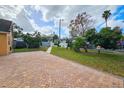 Landscaped backyard with a brick patio at 7211 Waycross Ave, Tampa, FL 33619