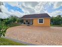 Charming yellow house with brick driveway at 7211 Waycross Ave, Tampa, FL 33619
