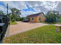 Nice yellow house with a large brick driveway at 7211 Waycross Ave, Tampa, FL 33619