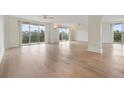 Spacious living room with light wood floors and access to a balcony at 2699 Seville Blvd # 403, Clearwater, FL 33764