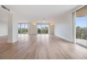 Bright living room featuring hardwood floors and large windows at 2699 Seville Blvd # 403, Clearwater, FL 33764