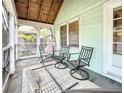 Relaxing screened porch with wooden ceiling, chairs, and a hanging chair at 2828 Burlington N Ave, St Petersburg, FL 33713