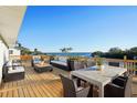 Spacious waterfront deck with patio furniture and fire pit at 380 Colony Point S Rd, St Petersburg, FL 33705