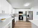 Bright kitchen featuring white cabinets and stainless steel appliances at 3932 Ashwood Ln # 42, Sarasota, FL 34232
