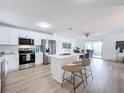Modern kitchen with white cabinets, stainless steel appliances, and island at 3932 Ashwood Ln # 42, Sarasota, FL 34232