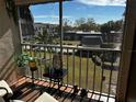 Relaxing balcony view overlooking the community pool and lush landscaping at 8765 Bardmoor Blvd # 308, Seminole, FL 33777